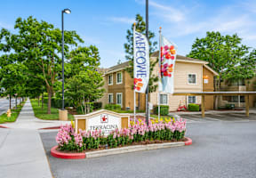 A sign that says "Welcome" stands in front of a building.