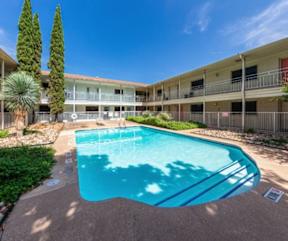 Outdoor swimming pool with sundeck and courtyard at Creekline Apartments, Texas
