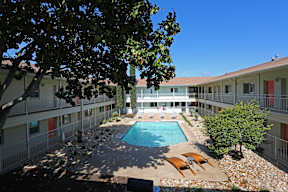 Courtyard pool area with lounge chairs at Creekline Apartments, Austin, TX 78757