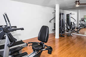 Fitness center with weight training machines at Creekline Apartments, Austin
