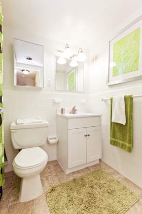 A white toilet sits next to a sink in a bathroom.
