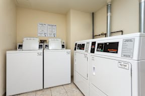 A row of washing machines in a laundromat.