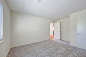 A room with carpeted floor and white walls.