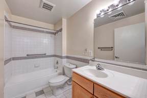 A white toilet sits next to a white sink in a bathroom.
