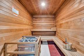 The Monmouth Manasquan, NJ - A wooden sauna with benches and a bucket.
