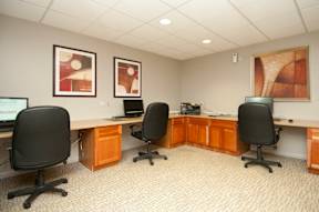 A room with a desk and chairs at Dominion Towers Apartments, Virginia