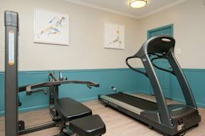 A treadmill and a stationary bike are in a room at Dominion Towers Apartments, Arlington, Virginia
