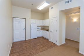 A kitchen with white appliances and cabinets.
