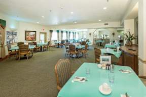 A dining room with tables set for a meal.