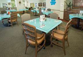 A restaurant with tables and chairs set up for dining.