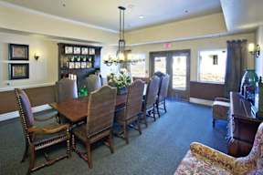 A room with a long table and chairs.