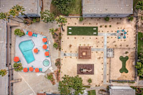 A playground with a blue slide and orange chairs.