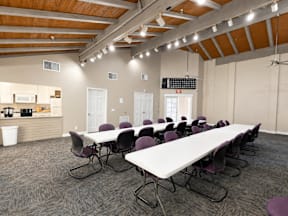 A conference room with a long table and chairs.