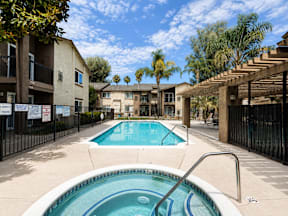 A pool in a courtyard surrounded by buildings.