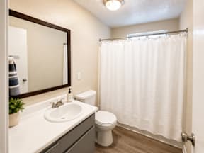 A white toilet sits next to a sink in a bathroom.