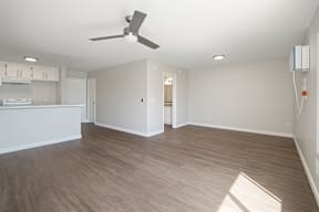 A room with a ceiling fan and lighting fixtures.