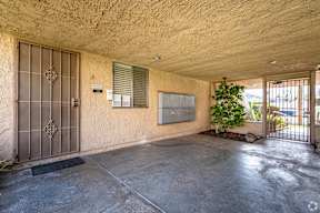 A concrete room with a door and a window.