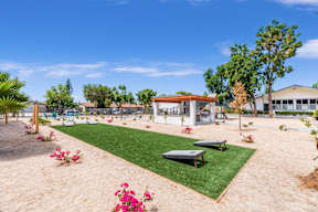 A park with a playground and a picnic table.