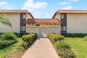 A building with a red tile roof and a white garage door.