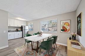 A dining room with a table and chairs.