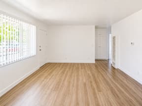 A room with wooden floors and white walls.