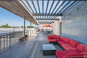 A patio with red couches and a table.