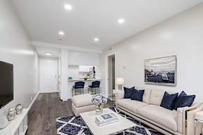 A modern living room with a white sofa and a coffee table.