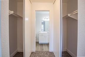 A white bathroom with a sink and mirror.