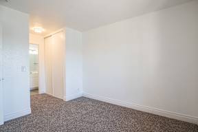 A room with a carpeted floor and white walls.
