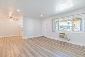 A room with a window and a ceiling fan.