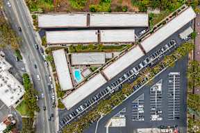 A parking lot with cars and a building in the background.