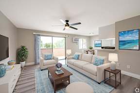 A living room with a couch, a coffee table, and a ceiling fan.