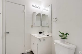 a bathroom with a sink and a mirror and a toilet at University Park, Azusa, 91702