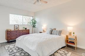 a bedroom with a white bed and a dresser at University Park, Azusa, 91702