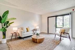 a living room with a couch and a coffee table and a sliding glass door at University Park, California, 91702