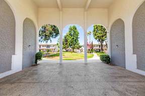 the archway of a building with a view of the grass at Sunnymead Apts Apartments, Moreno Valley, CA, 92553