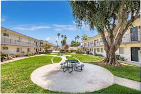 a park with a picnic table and a tree in a courtyard at Sunnymead Apts Apartments, California, 92553