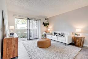 a living room with a couch and a coffee table and a sliding glass door at Alosta Place, California, 91702