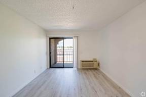 the preserve at ballantyne commons apartment living room with wood flooring and balcony at Flamingo Garden Senior Apts, El Monte