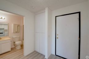 a bedroom with a door leading into a bathroom with a toilet and sink at Flamingo Garden Senior Apts, El Monte California