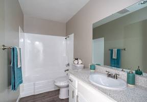 a bathroom with a sink toilet and a mirror at North View Terrace, Montebello, CA