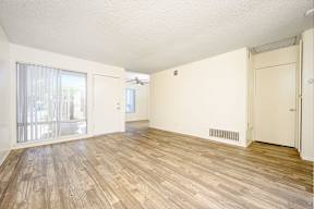 a bedroom with hardwood floors and white walls at Villa Hemet, Hemet