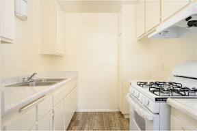 a kitchen with white cabinets and a white stove top oven at Villa Hemet, Hemet, CA 92543