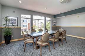 A conference room with a table and chairs.