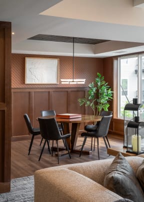 a dining room with a wooden table and chairs