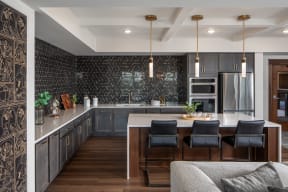 a kitchen with a large island and a table with chairs