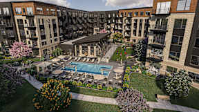 A large apartment complex with a pool and patio area.