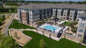 an aerial view of an apartment building with a swimming pool