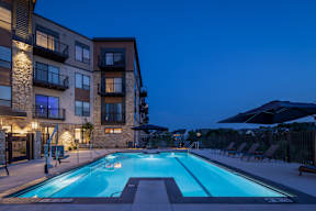 A swimming pool in front of a residential building.
