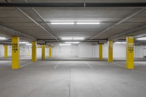 an empty parking garage with yellow pillars in the ground